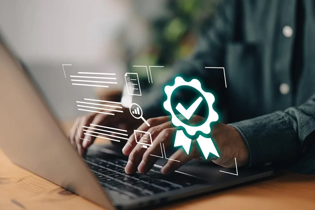 Hands on a laptop with a certification badge overlay